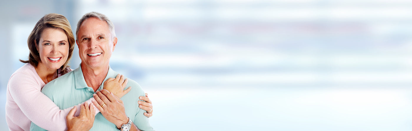 Man and woman embracing with a blurred light blue background
