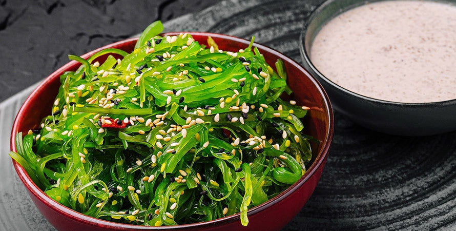 Seaweed salad with wakame sesame oil and sesame seeds in a bowl